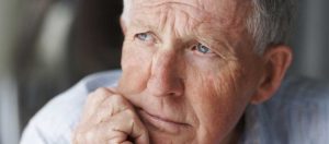 Older retired man with concerned expression on face